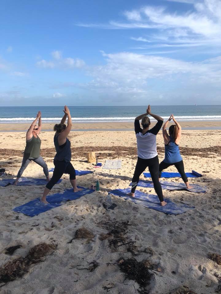 Yoga with friends at the beach