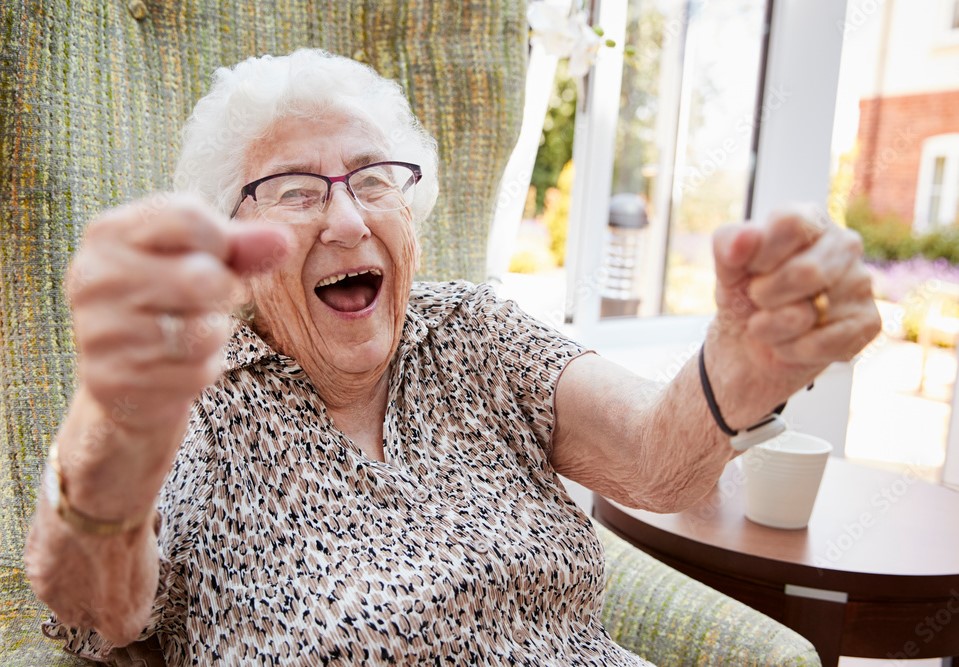 Elderly woman cheering with happiness and a big smile